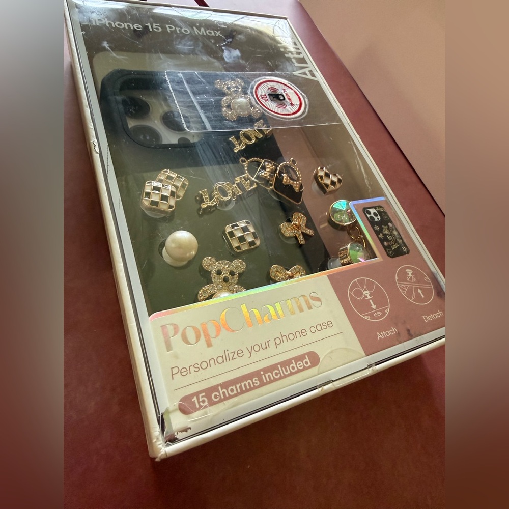iPhone 15 Pro Max Case with personalizable gold charms.